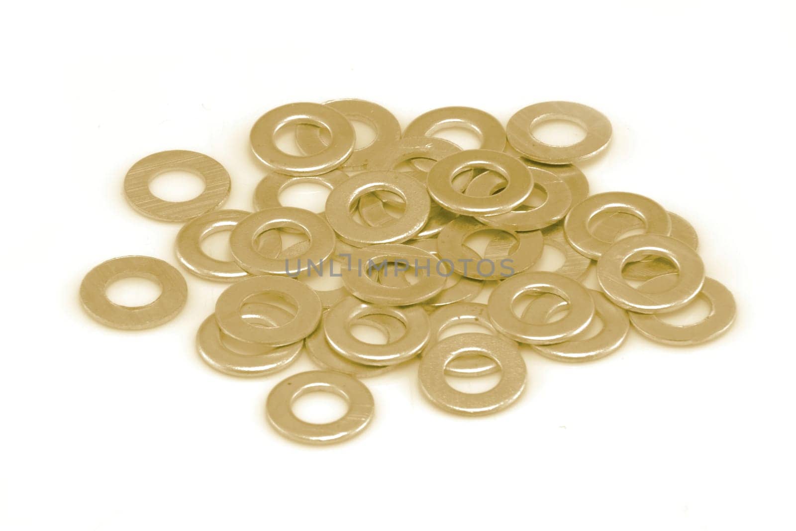 A pile of gold coloured washers on white background