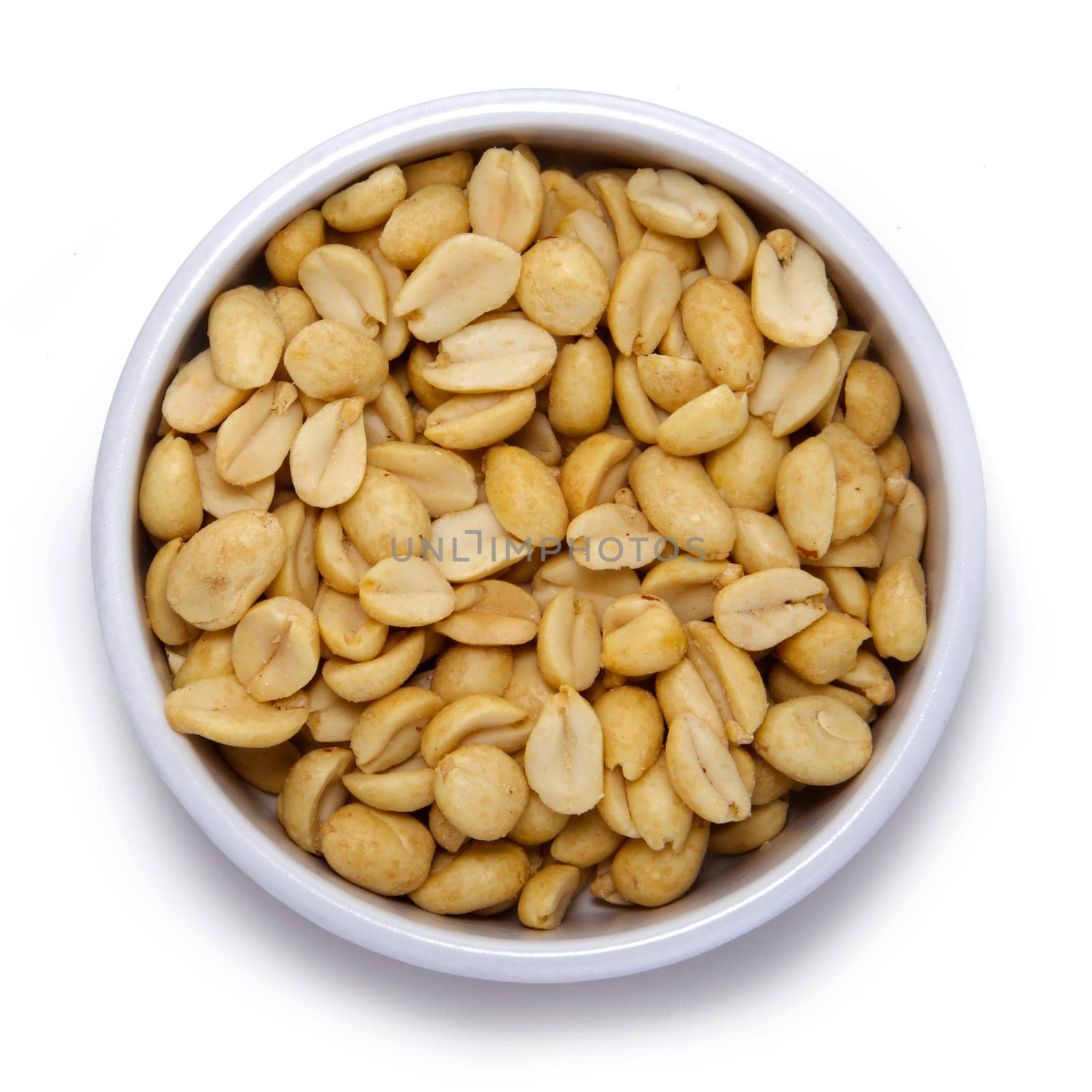 Roasted peanuts in round container on a white background