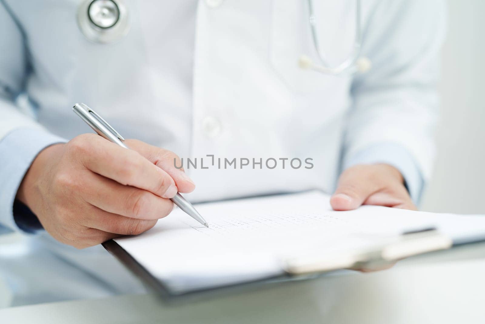 Asian man doctor study document to research method and technic for treating patients.