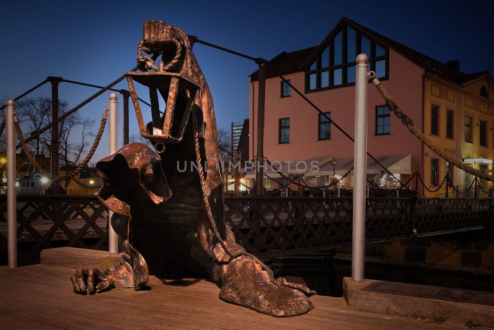 City attraction - statue in old port of Klaipeda, Lithuania. Legend of black no-face ghost with a lantern in gnarled hand come out of harbor waters.