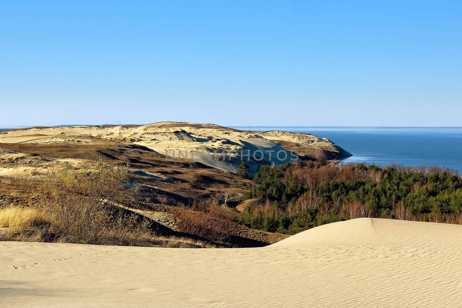 View of nordic dunes, hills and Baltic sea harbor at Curonian spit, Nida, Klaipeda, Lithuania. White sand patterns, waves. geometry.
