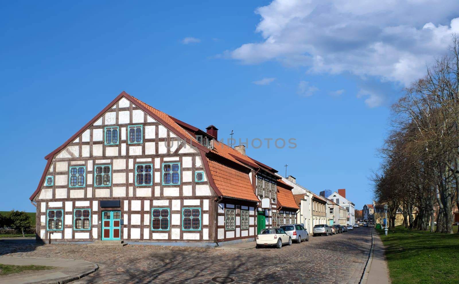 Typical or traditional fachwerk house of old Klaipeda, Lithuania medieval town and cobbled pavement street. German style buildings of Middle Ages.