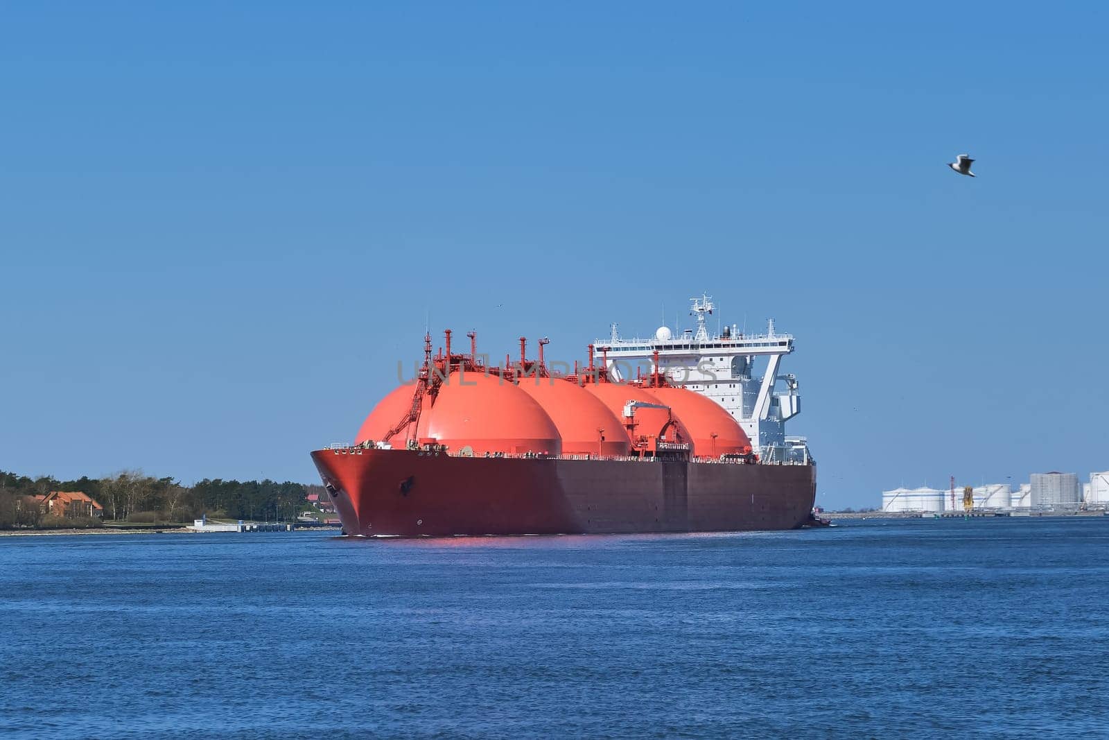 LNG or liquified natural gas tanker entering port on a sunny day in Klaipeda, Lithuania. Alternative gas supply, commercial freight, energy crisis