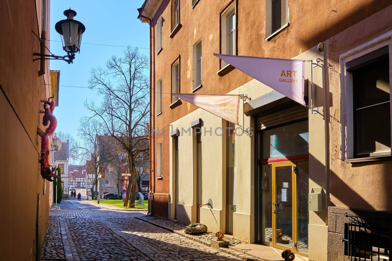 Cobbled pavements of old town streets in Klaipeda, Lithuania on sunny day. Old buildings, houses, galleries, shops, restaurants.