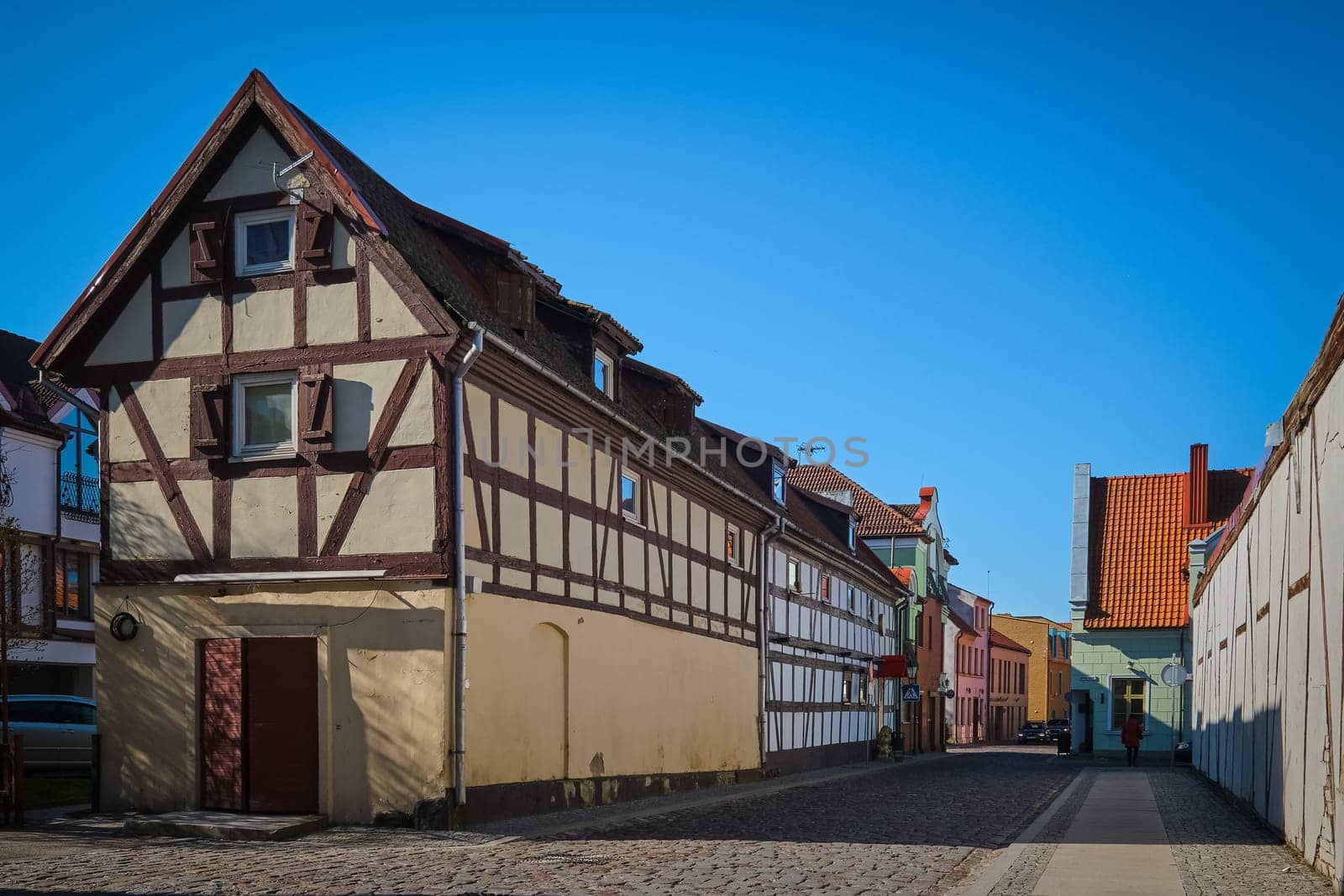 Typical fachwerk house of old Klaipeda, Lithuania medieval town and cobbled pavement street. German style buildings of Middle Ages.