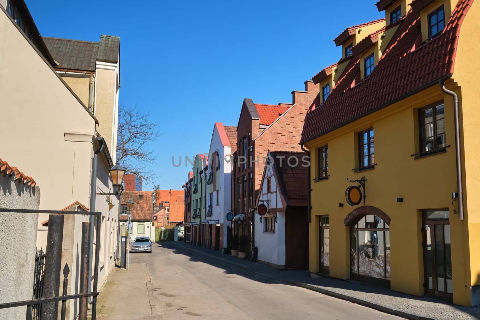 Cobbled pavements of old town streets in Klaipeda, Lithuania on sunny day. Old buildings, houses, galleries, shops, restaurants.