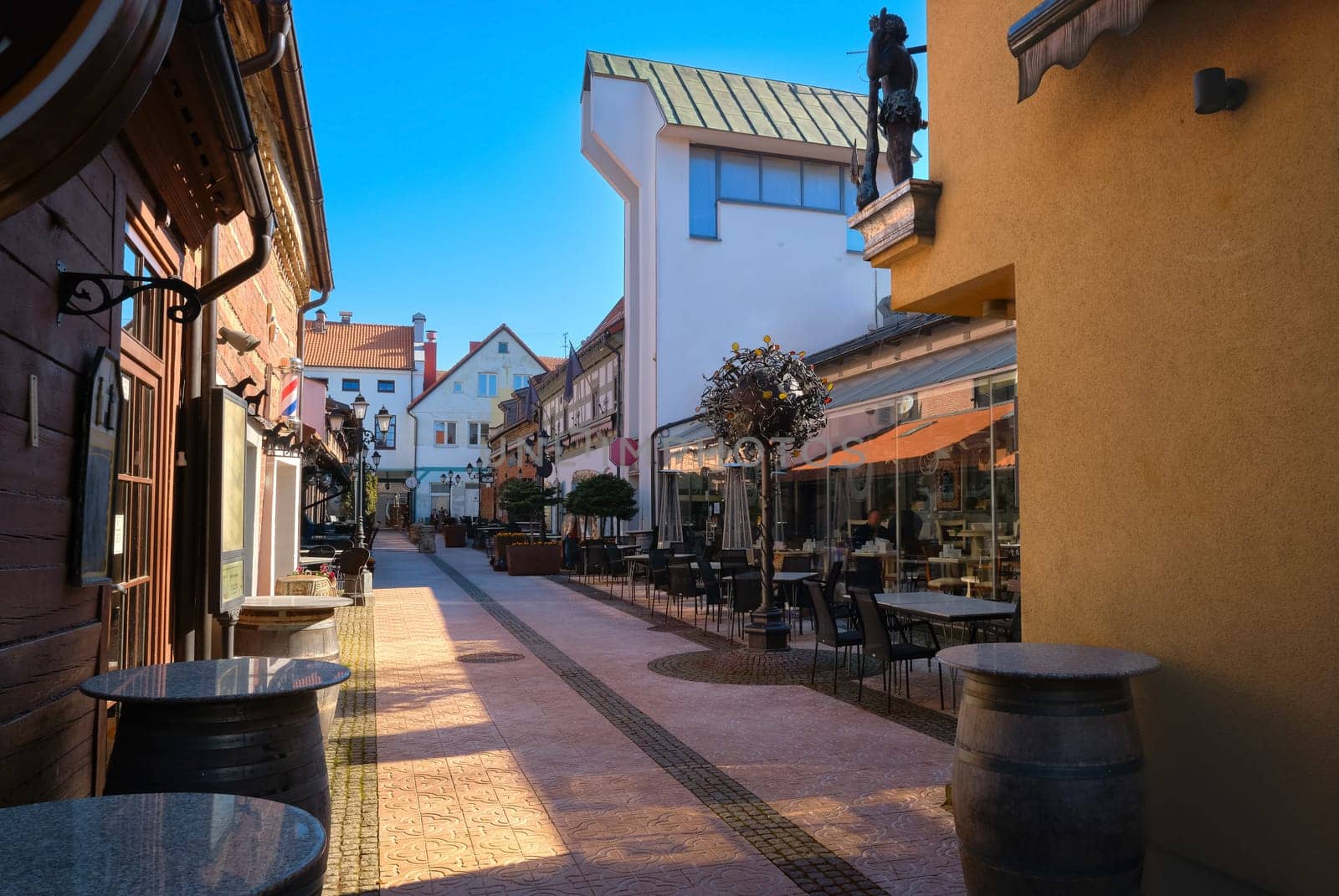 Cobbled pavements of old town streets in Klaipeda, Lithuania on sunny day. Old buildings, houses, galleries, shops, restaurants.