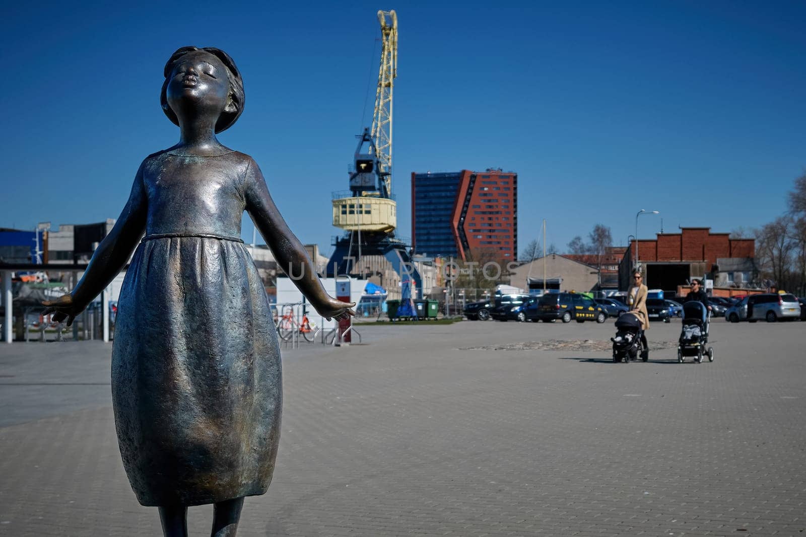 City attraction. Statue of unknown little girl in port of Klaipeda, Lithuania on sunny day.