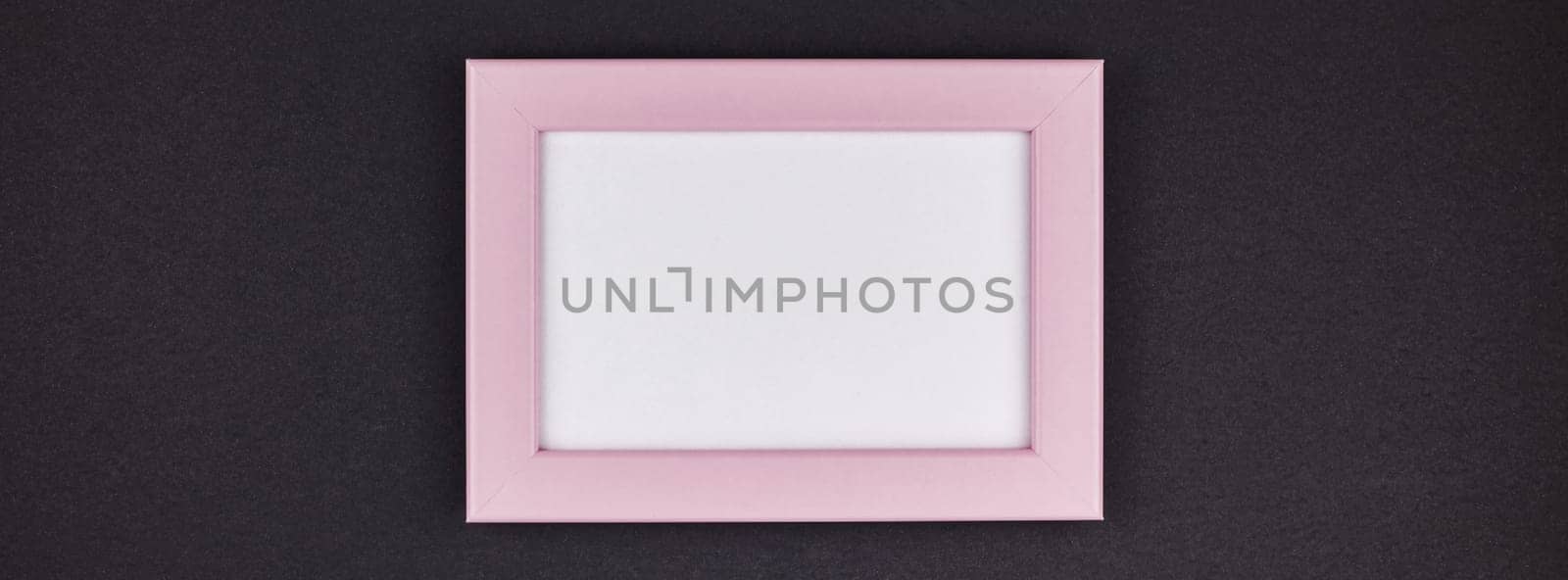 Mock up of a millennial pink frame on dark black color paper background with copy space in minimal style, template for text or your image mockup. Long wide banner