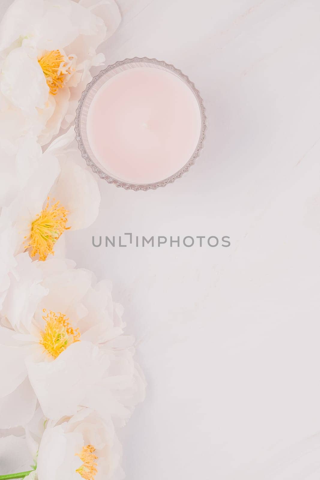Beautiful blooming white peony flowers on marble background with copy space in minimal style, template for postcard, lettering, text or your design. Wedding invitation and celebration greeting concept