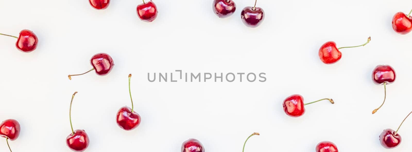 Long wide banner of fresh ripe cherry pattern layout with copy space isolated on white background in minimal style. Concept of summer fun and healthy eating. Template for your text or food design