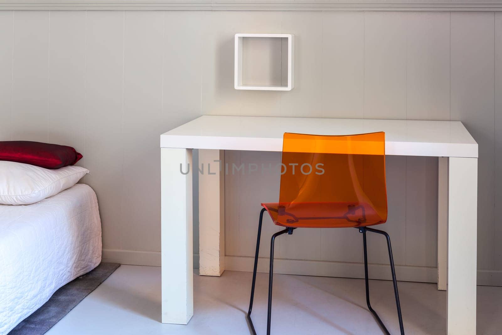 Bed, table and chair, scene in apartments room. Horizontal shot