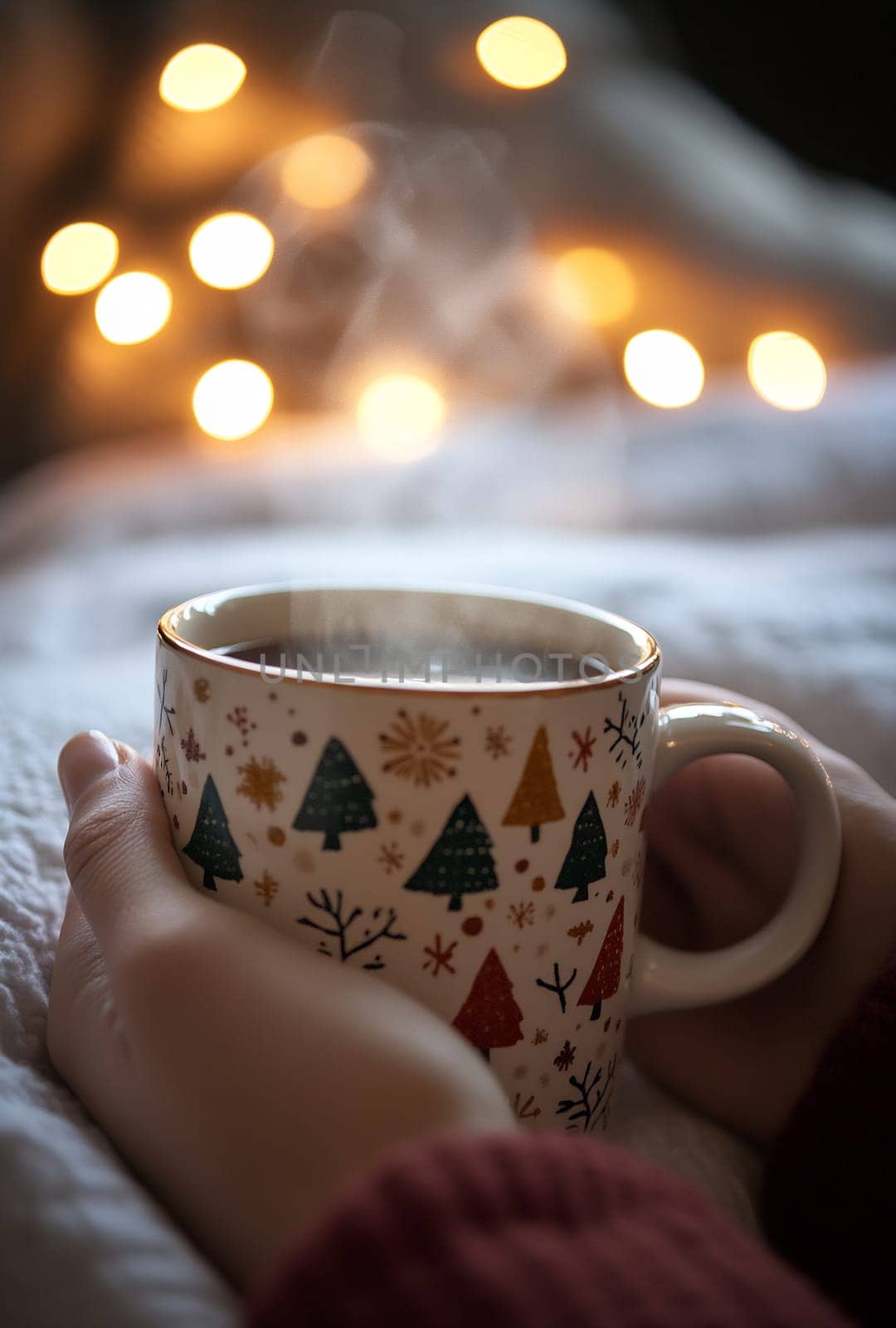 A warm mug rests in hands, sending steam into the air, accompanied by glowing lights and cozy blankets, perfect for a winter evening.