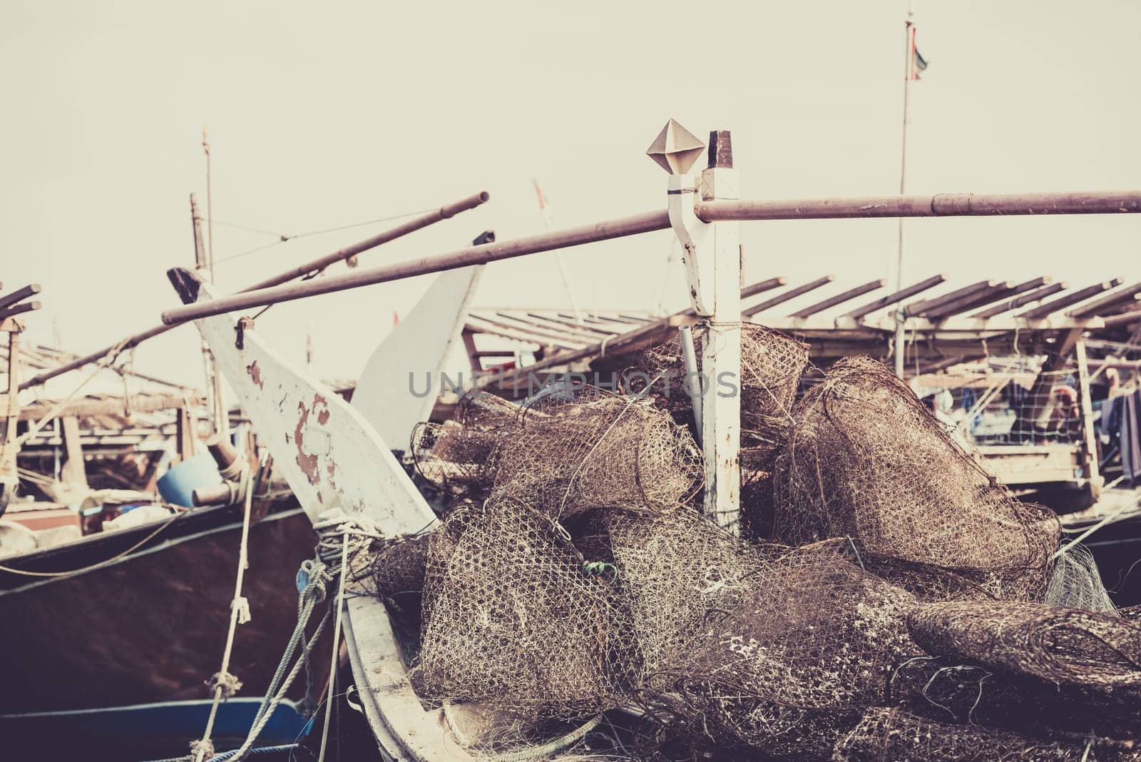 Old fishing boats with rusty metal nets in the Persian Gulf. Filtered shot