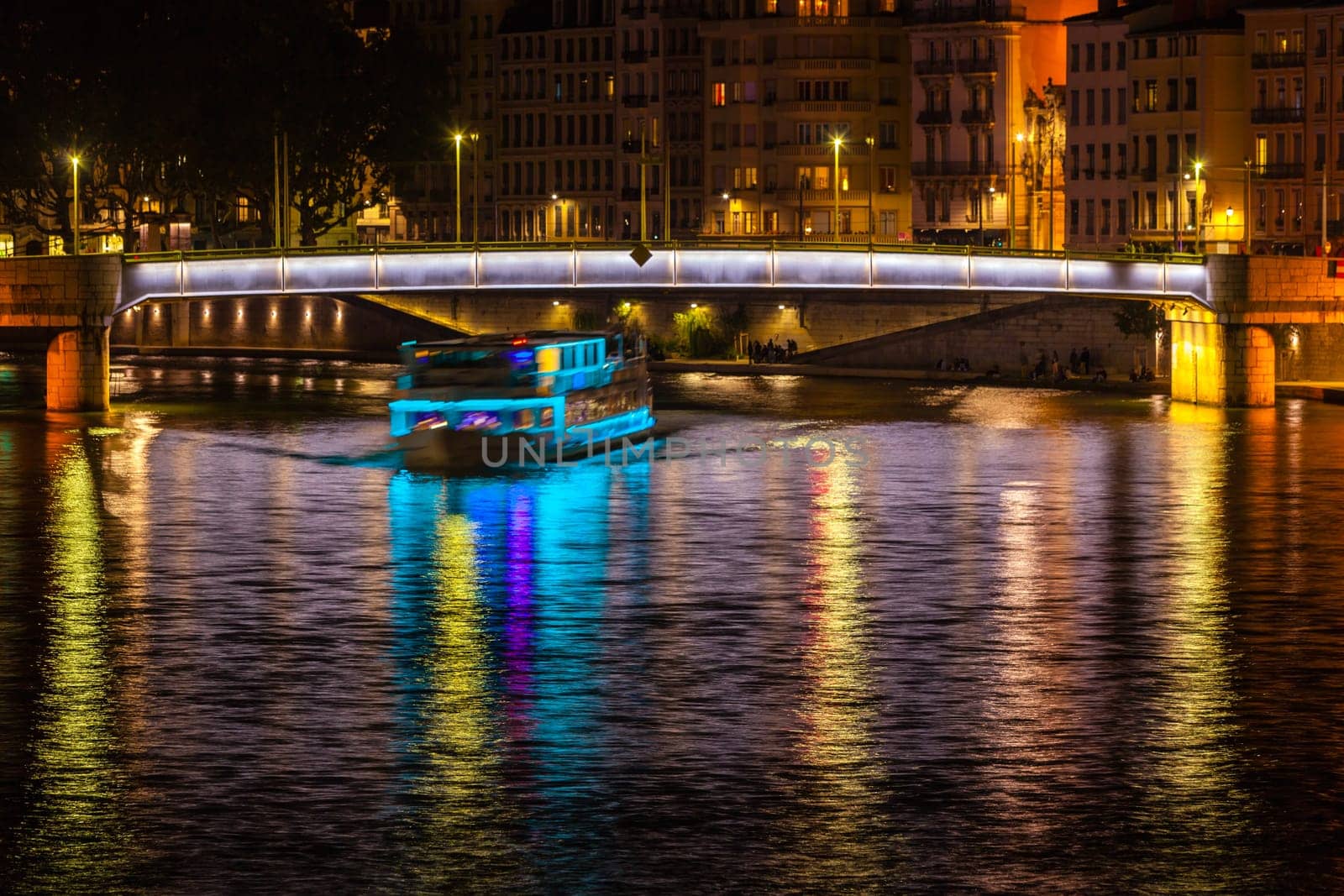 Cityscape of Lyon, France with reflections in the water at night