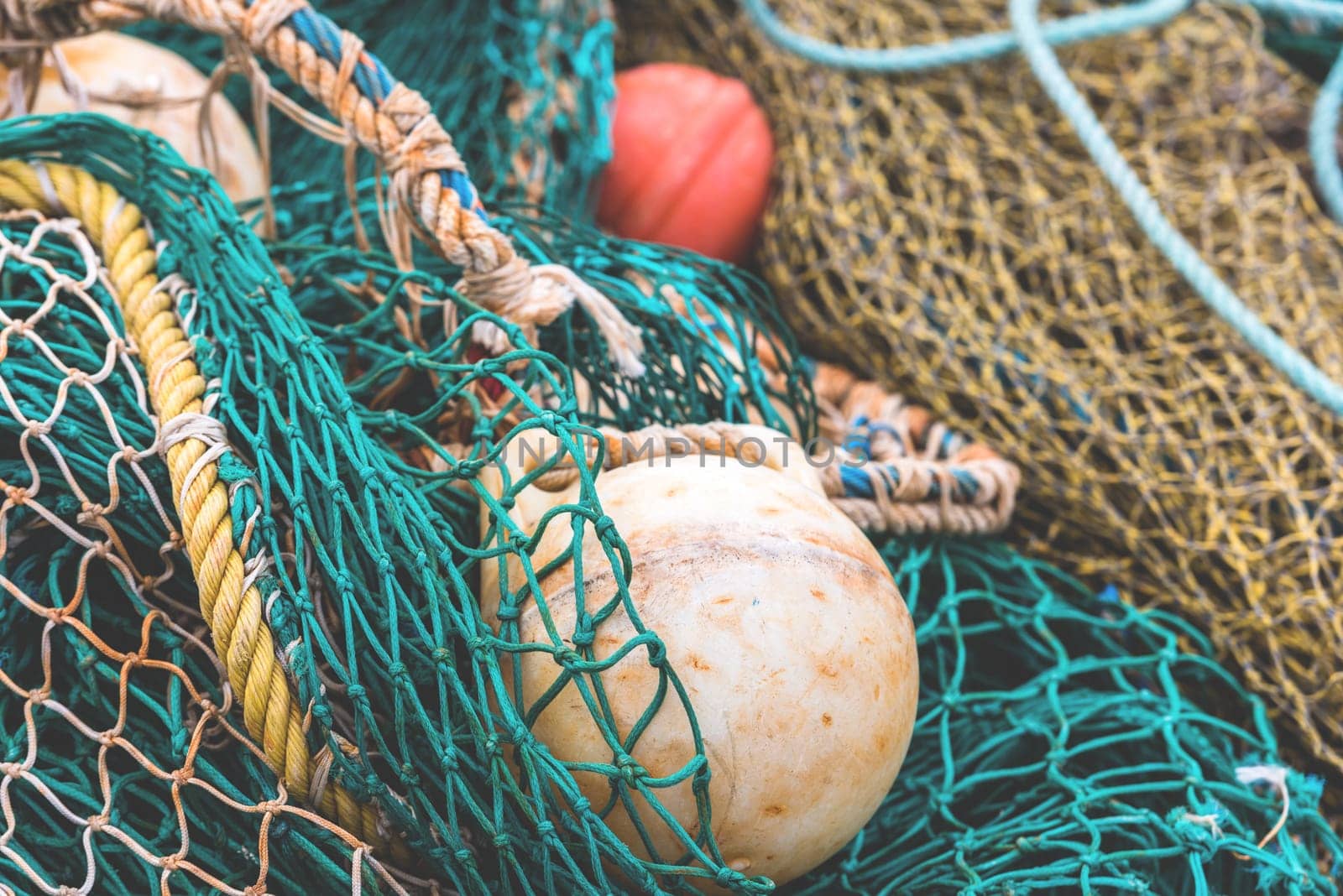 Green Fishing net with a buoys at the harbor. Close up