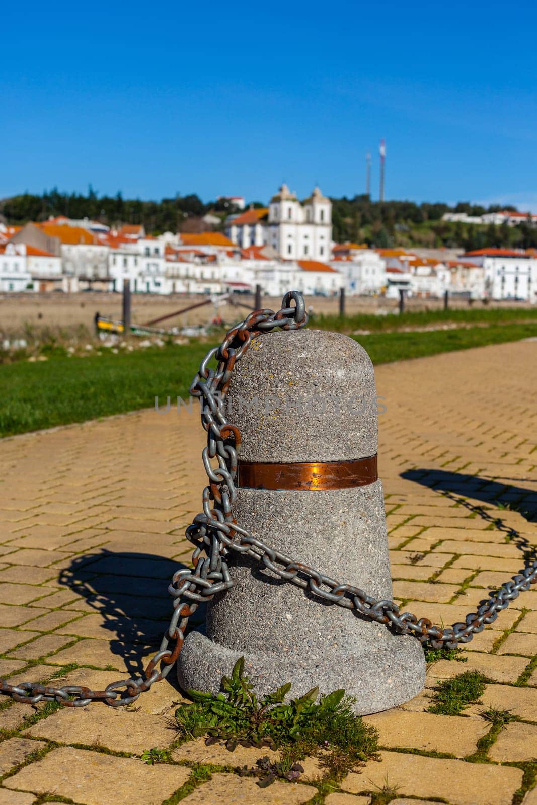 Stub posts linked in a chain on a quay in a small Portugal town