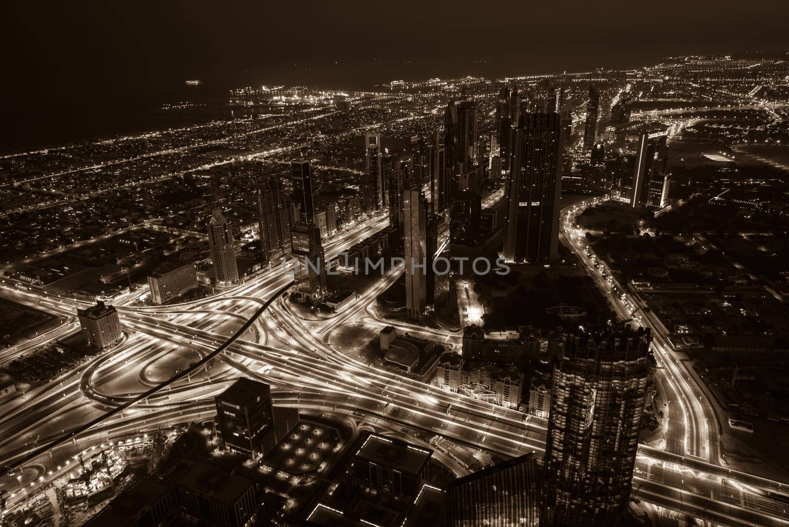 Dubai downtown night scene with city lights. Top view from above