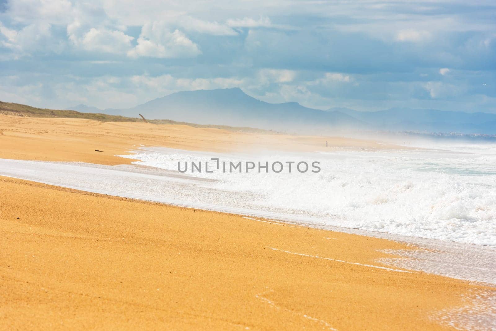 Long Sand Atlantic Beach with ocean waves. The Gironde Department, France. Shot with a selective focus