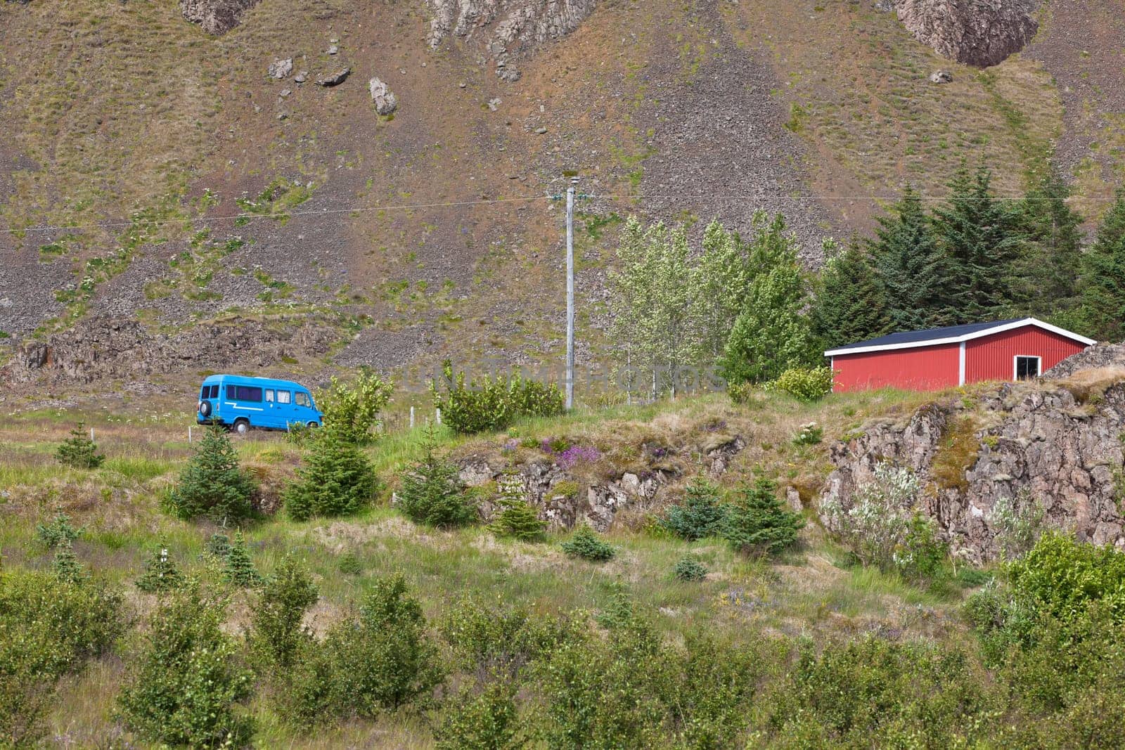 East Iceland Nature Landscape with rocks range, red house and blue minibus