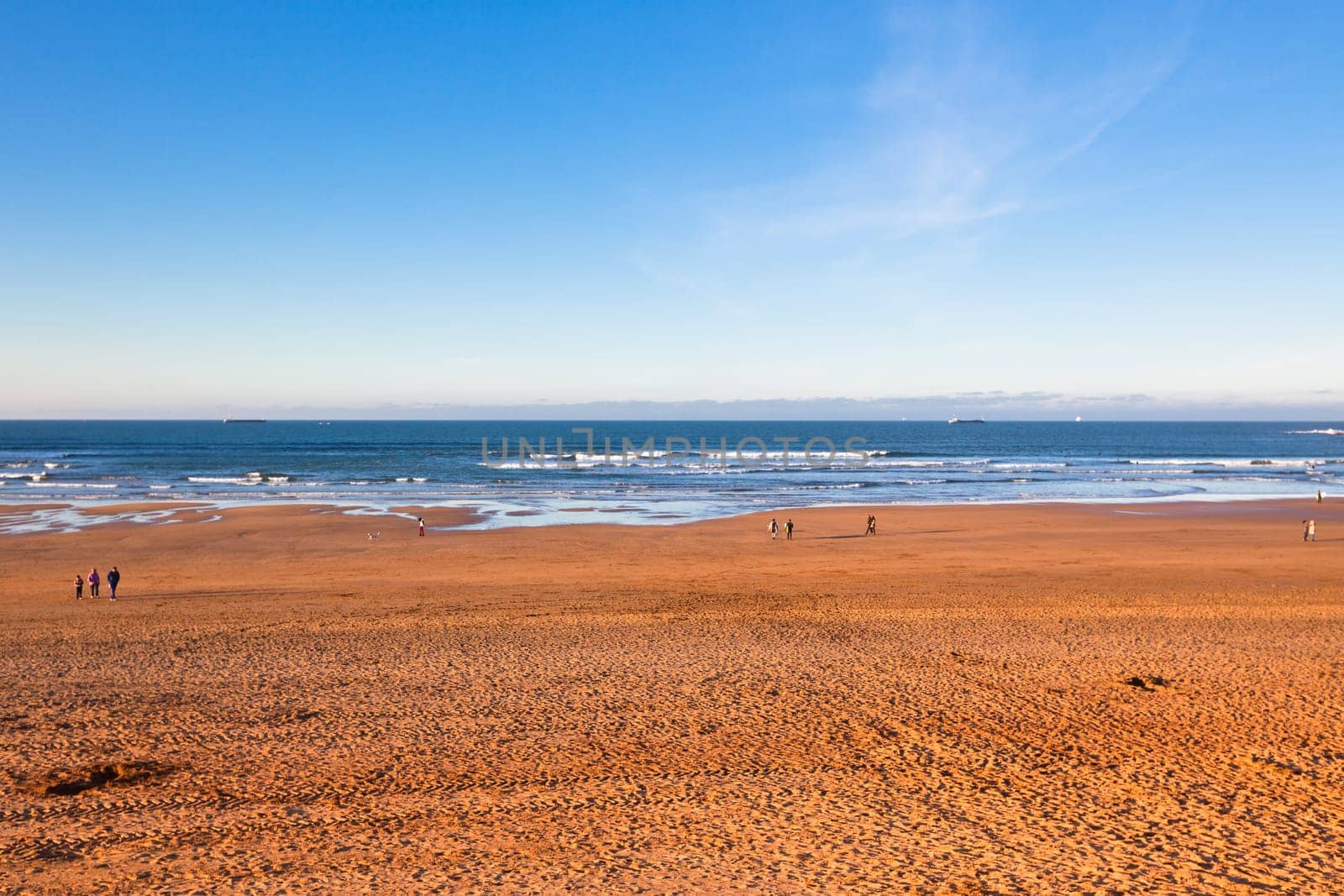 The Bay of Biscay near Bilbao, Spain in January: long beach and ocean before sunset time
