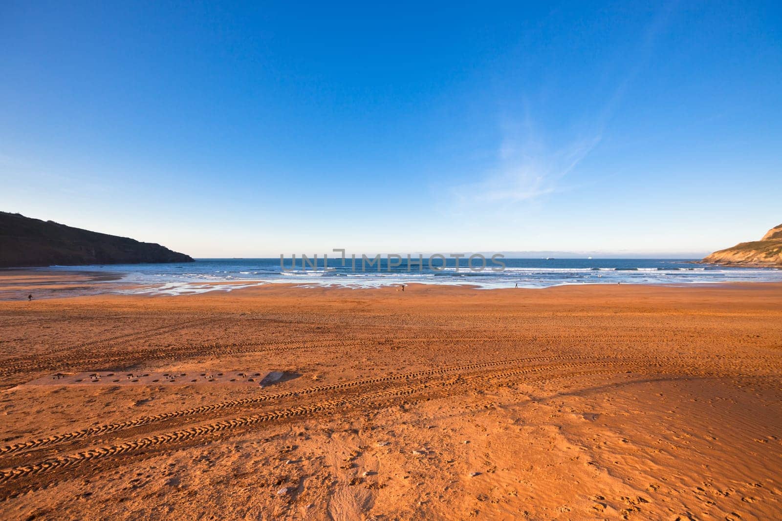 The Bay of Biscay near Bilbao, Spain in January: long beach and ocean before sunset time