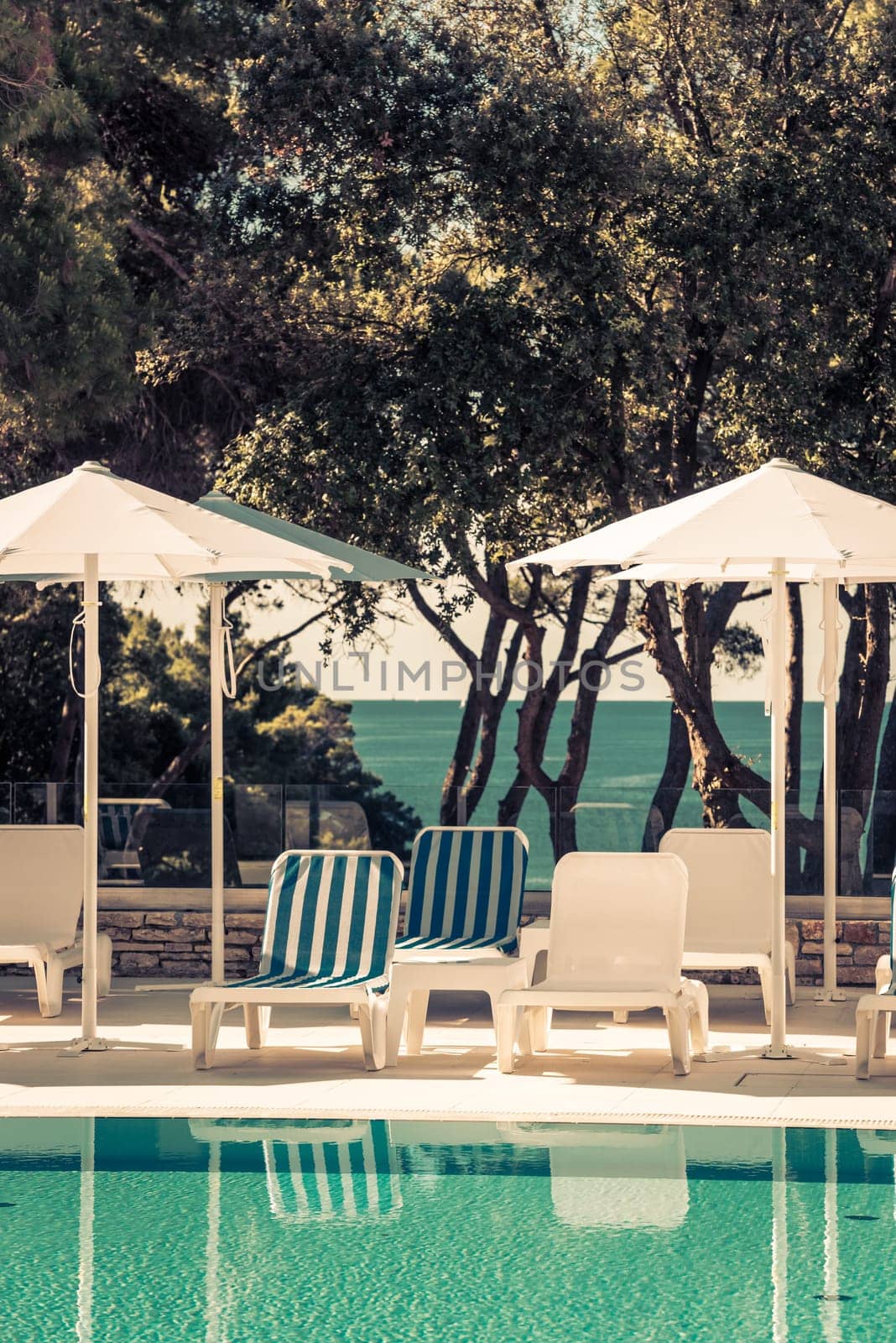 Hotel Poolside Chairs with Sea view. Filtered shot