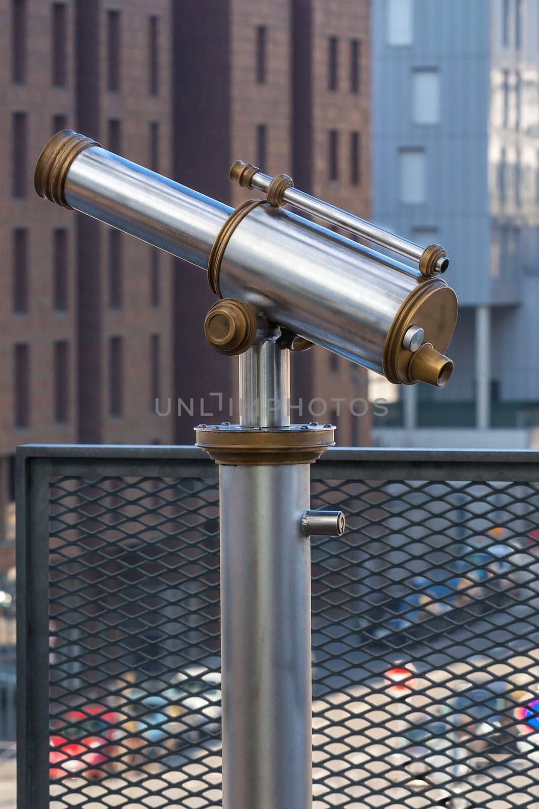 Telescope overlooking for city streets from above. Shot with a small GRIP