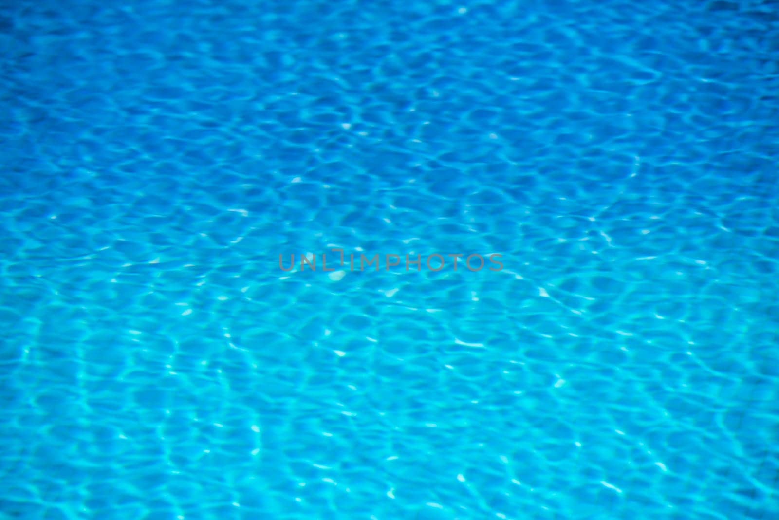 Clear transparent pool water background. Filtered blur shot
