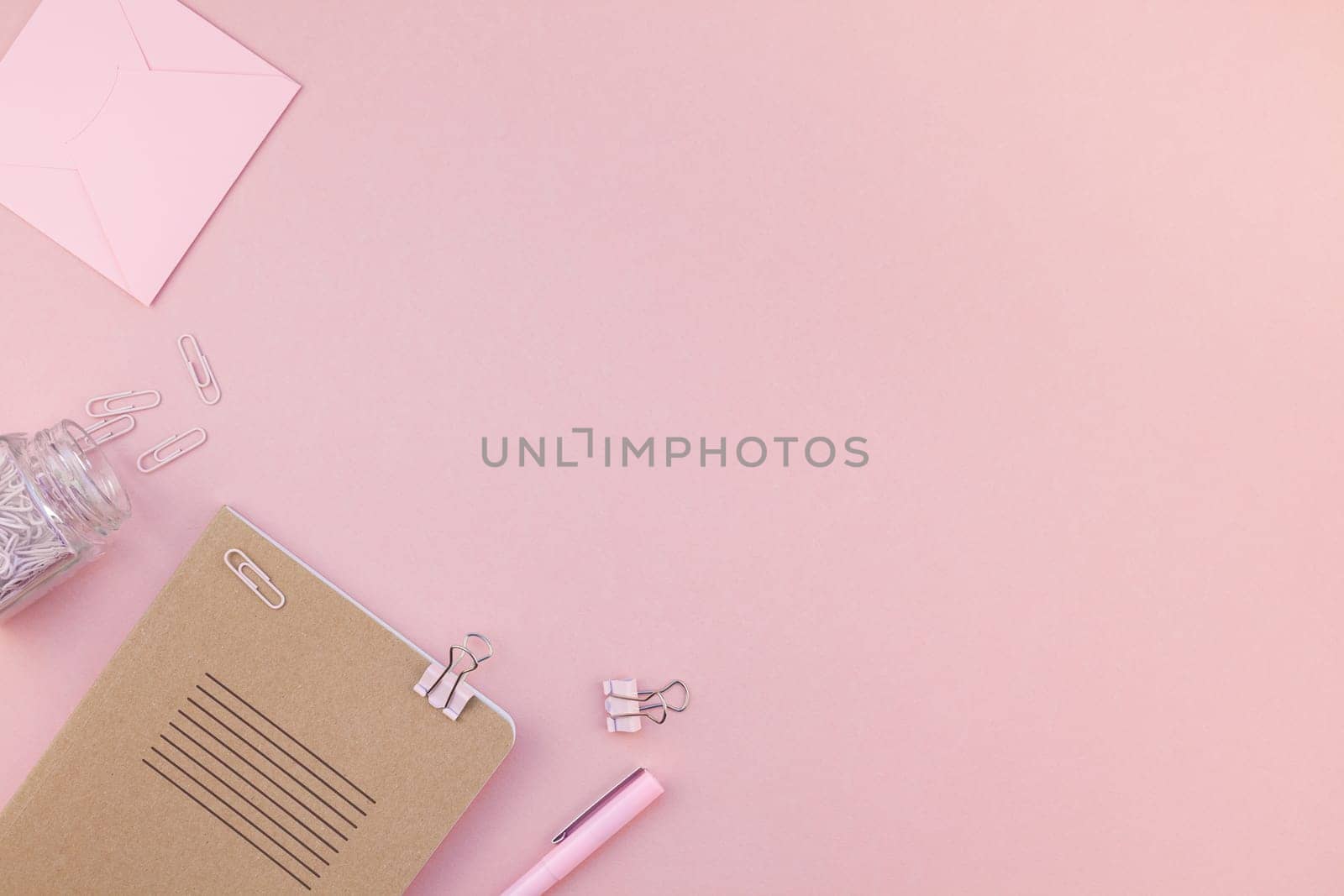Top view flat lay of woman workspace desk styled design office supplies with copy space on a millennial pink color paper background minimal style. Template for feminine blog social media