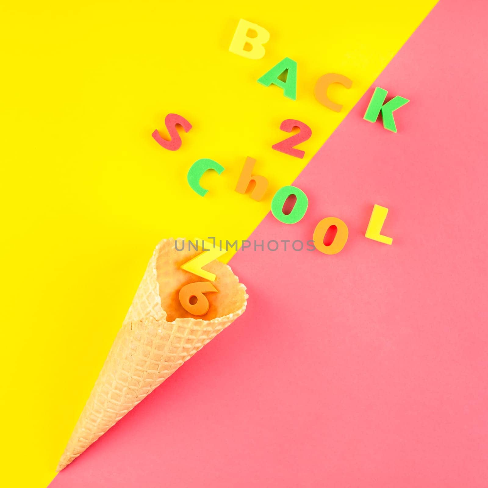 Square Creative flat lay back to school concept with waffle cone and welcome letters message on bright yellow and pink paper background with copy space, template for text or design