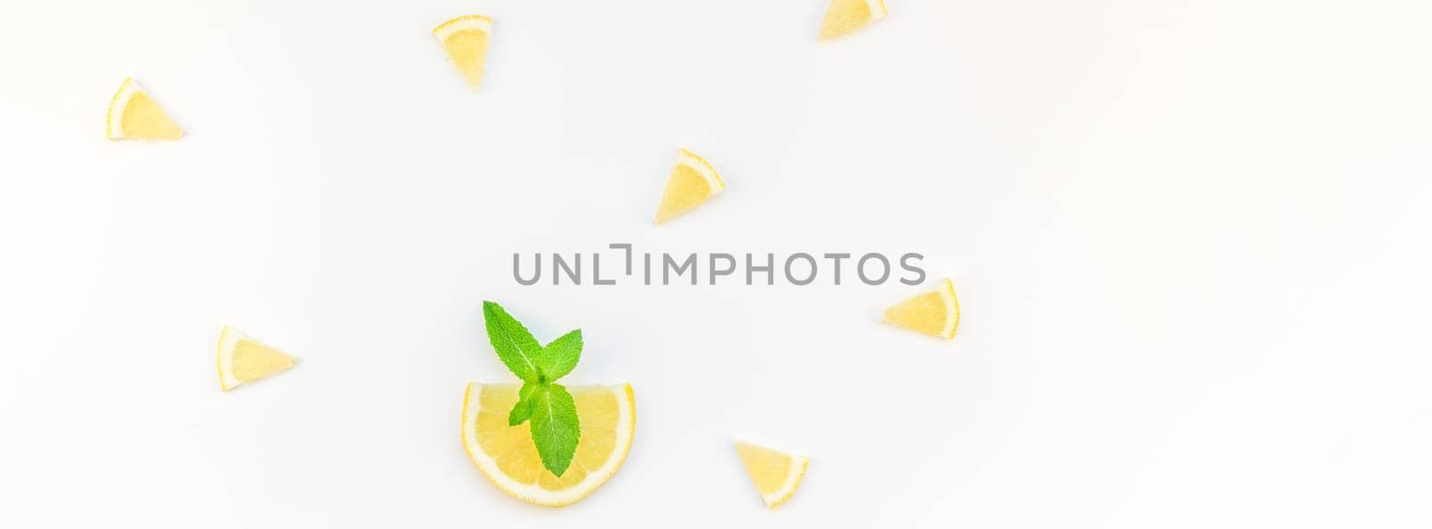 Long wide banner top view citrus lemon slices and mint herbs leaves white table background with copyspace. Hot summer refreshment lemonade concept. Beverage ingredients arranged