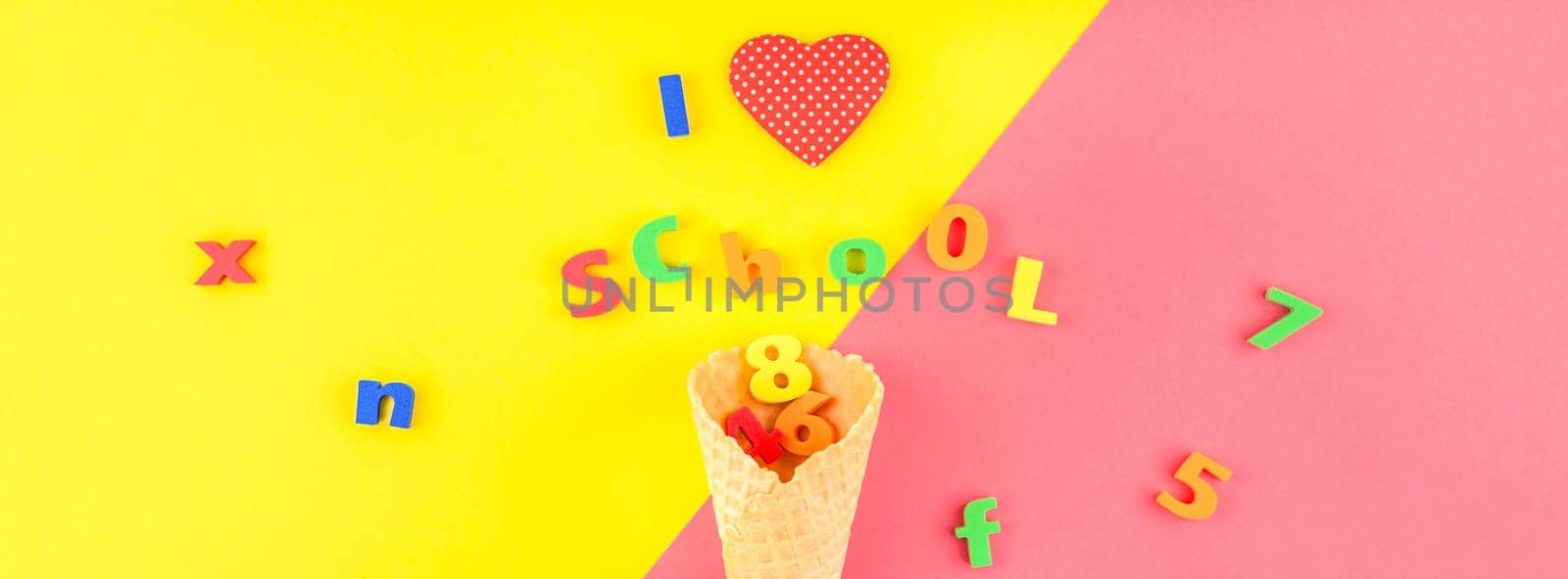 Creative flat lay back to school concept with waffle cone and welcome letters message on bright yellow and pink paper background with copy space, template for text or design. Long wide banner