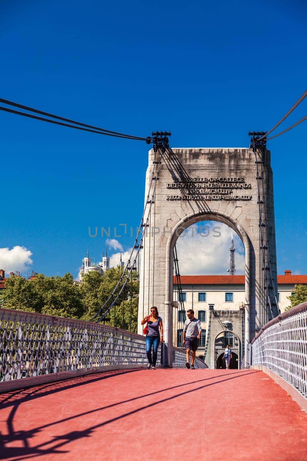 FRANCE, LYON - AUGUST 22: People are walking along Old Passerelle du College bridge over Rhone river in Lyon, France on August 22, 2014