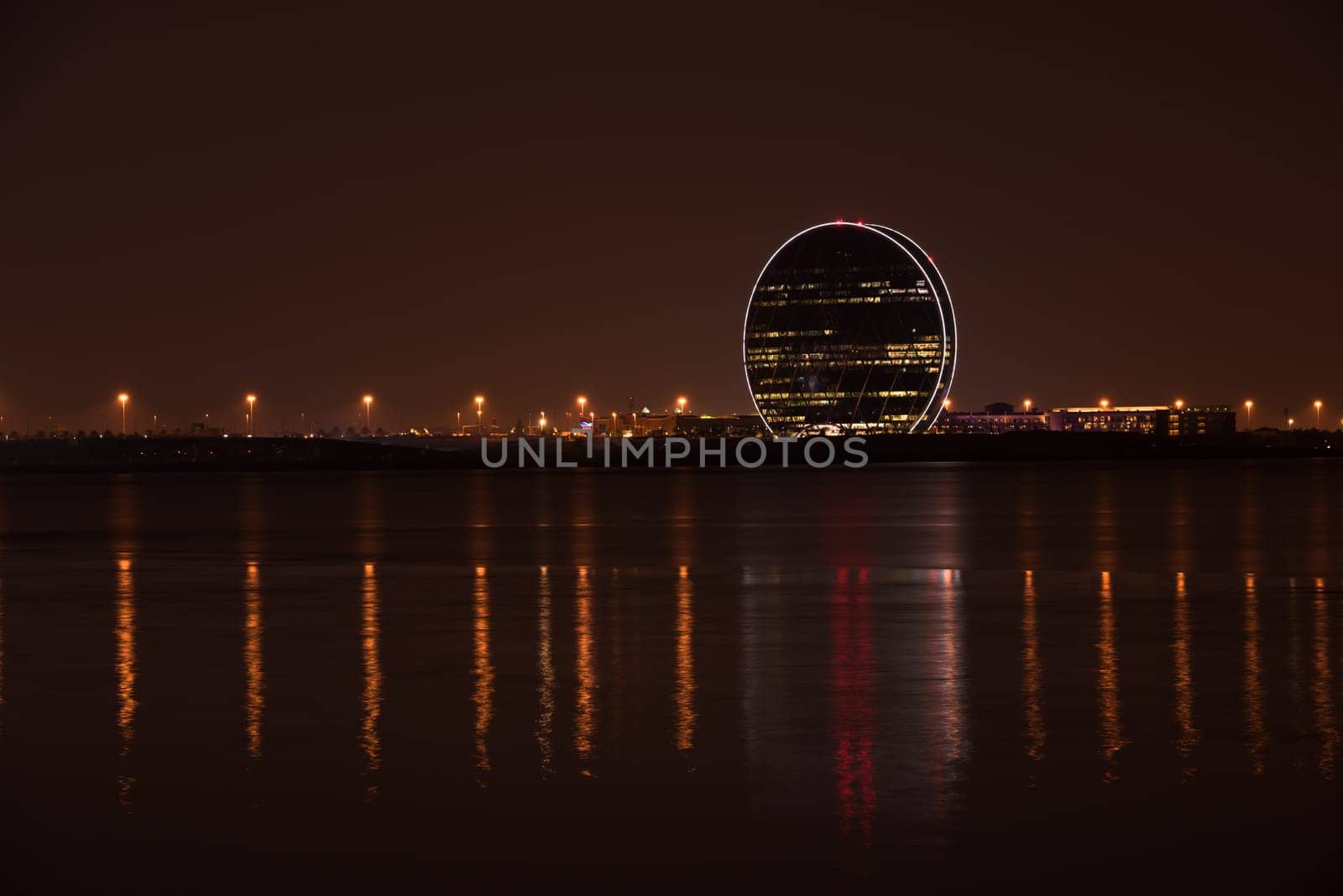 UAE, ABU DHABI - DECEMBER 20: View of Aldar headquarters building and night skyline of Abu Dhabi, UAE on December 20, 2014