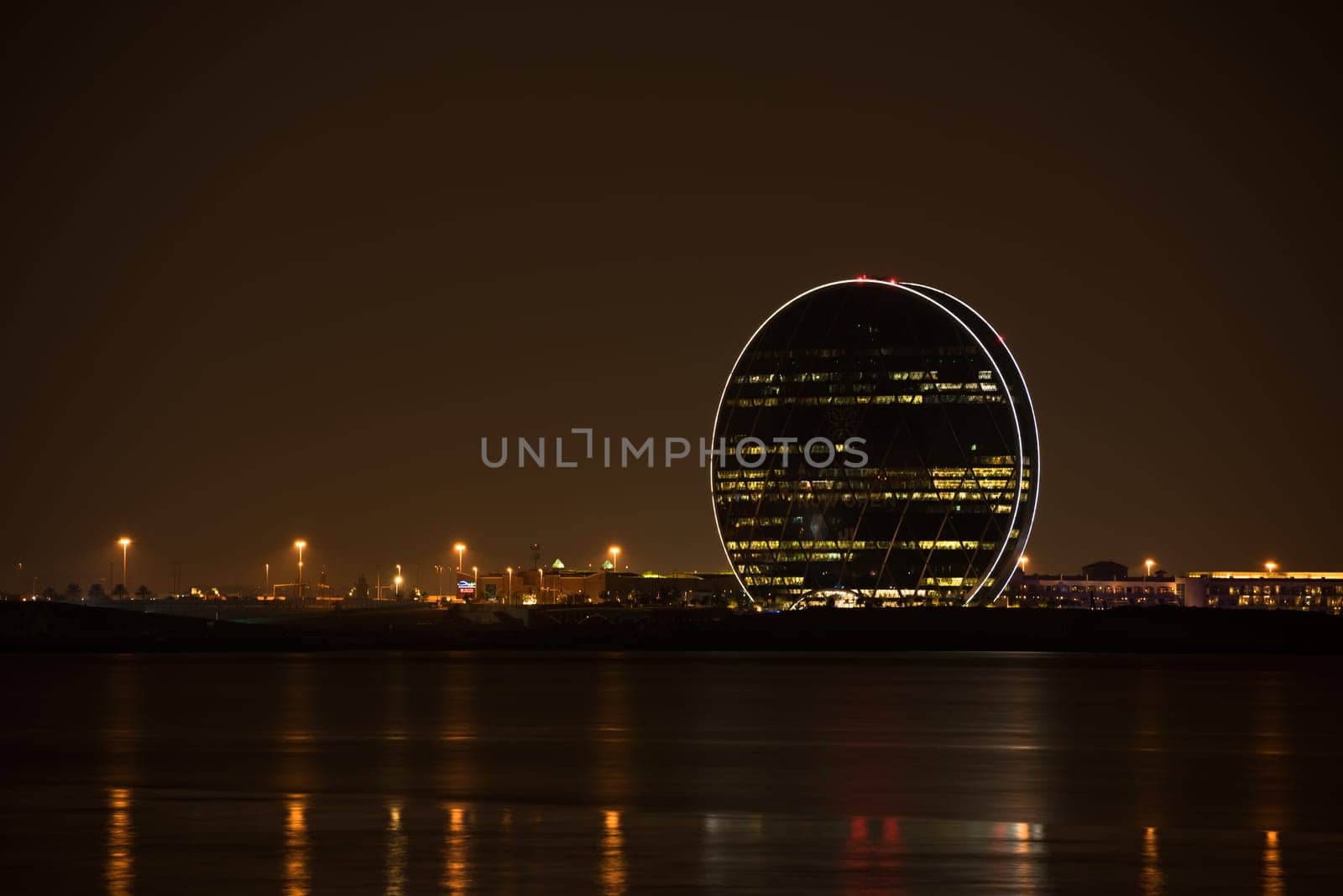 UAE, ABU DHABI - DECEMBER 20: View of Aldar headquarters building and night skyline of Abu Dhabi, UAE on December 20, 2014