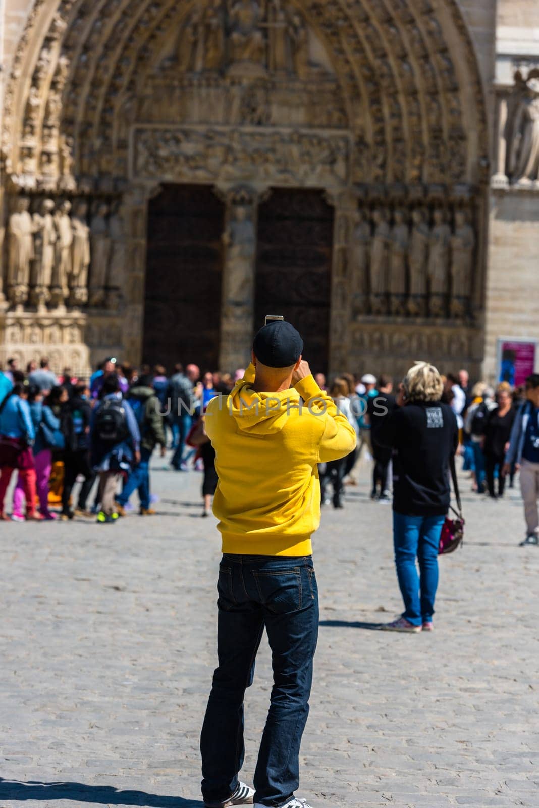 FRANCE, PARIS - JUNE 01: Man taking pictures of the Notre Dame Cathedral in Paris on June 01, 2015