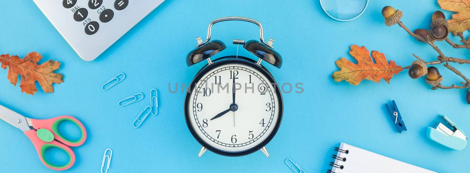 Creative flat lay top view back to school concept with color school and office supplies on bright turquoise paper table frame background with copy space, template for text or design. Long wide banner