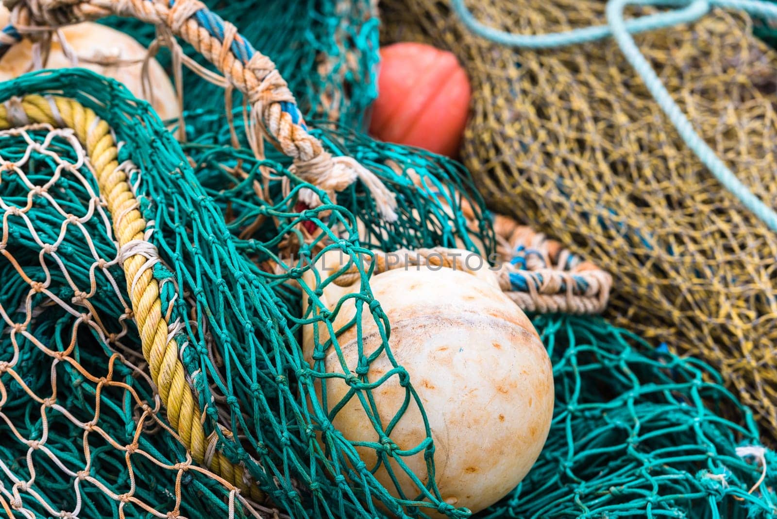 Green Fishing net with a buoys at the harbor. Close up