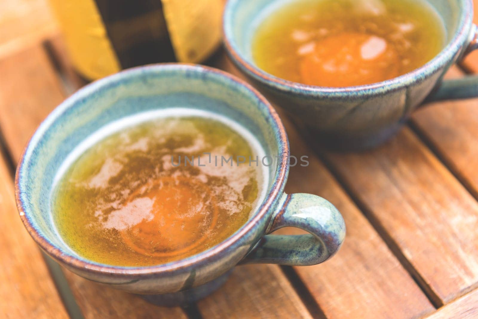 Norman apple cider in a typical ceramic cups. Shot with a selective focus
