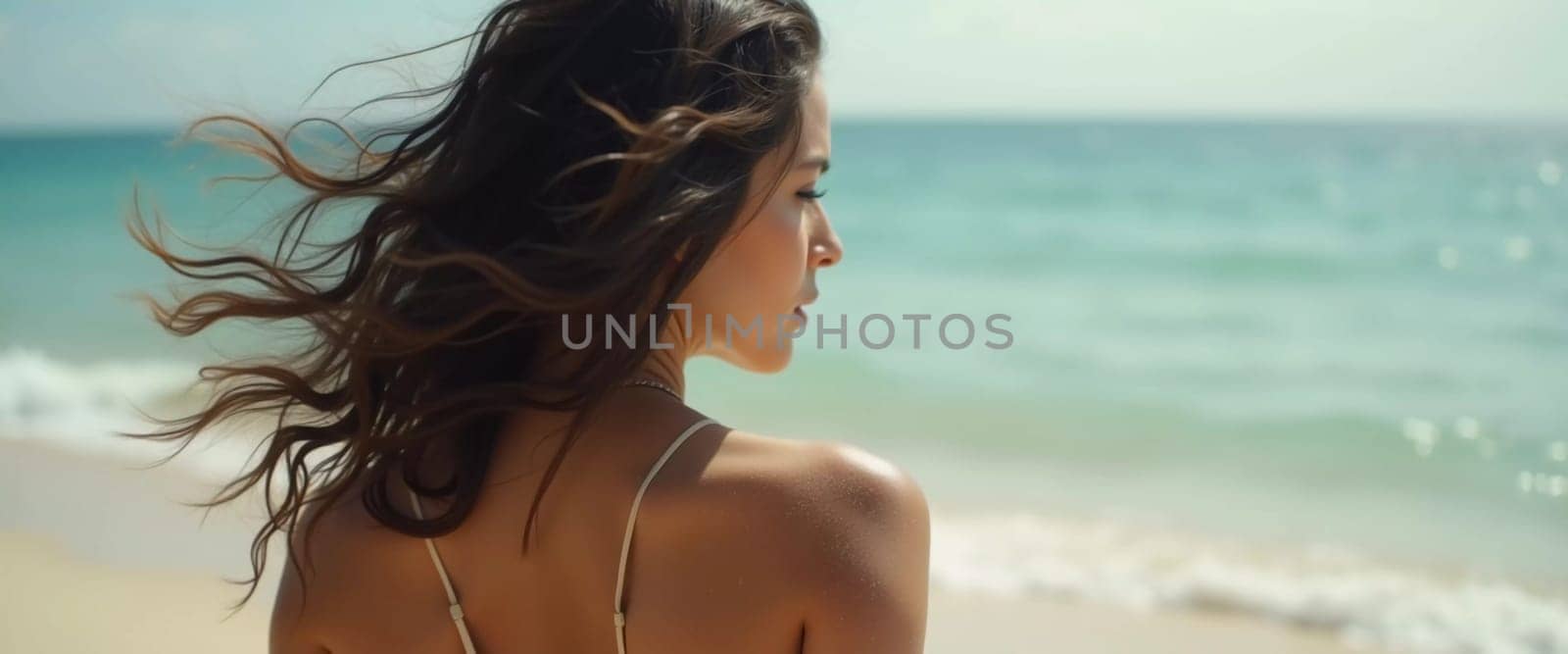 A brunette woman stands at the beach, her hair flowing in the breeze, enjoying a sunny day by the ocean while wearing a stylish swimsuit. The waves softly reach the shore. Generative AI.