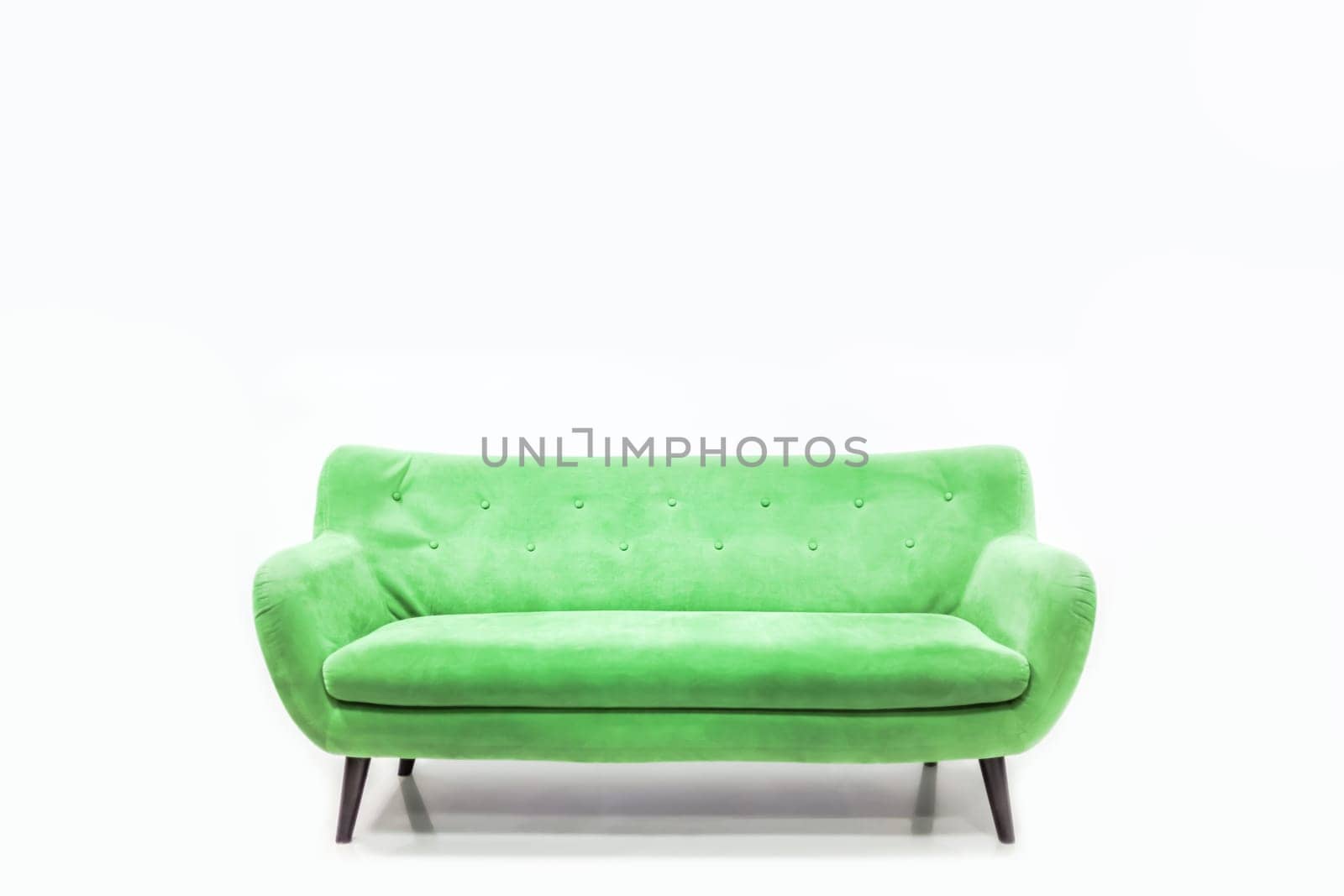 Minimal concept of living interior with bright green sofa on white floor and background. Scandinavian style wall mockup.
