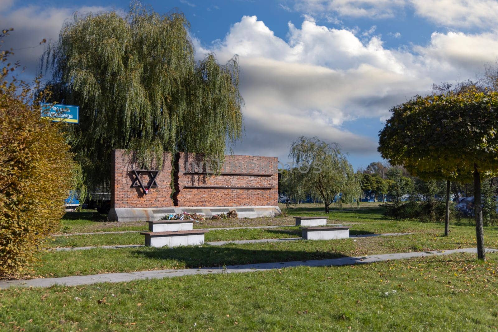 Czestochowa, Poland - October 18, 2024: Monument to Jews of Czestochowa, commemorates 40,000 Jews murdered in the Treblinka death camp. Star of David made of railway rails, crack in red brick wall