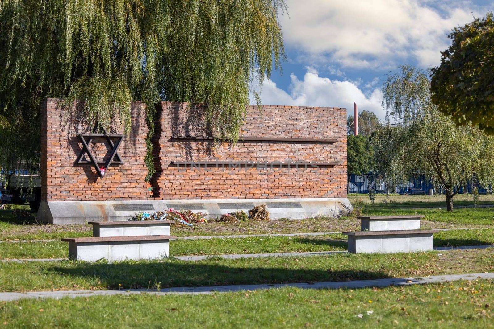 Czestochowa, Poland - October 18, 2024: Monument to Jews of Czestochowa, commemorates 40,000 Jews murdered in the Treblinka death camp. Star of David made of railway rails, crack in red brick wall