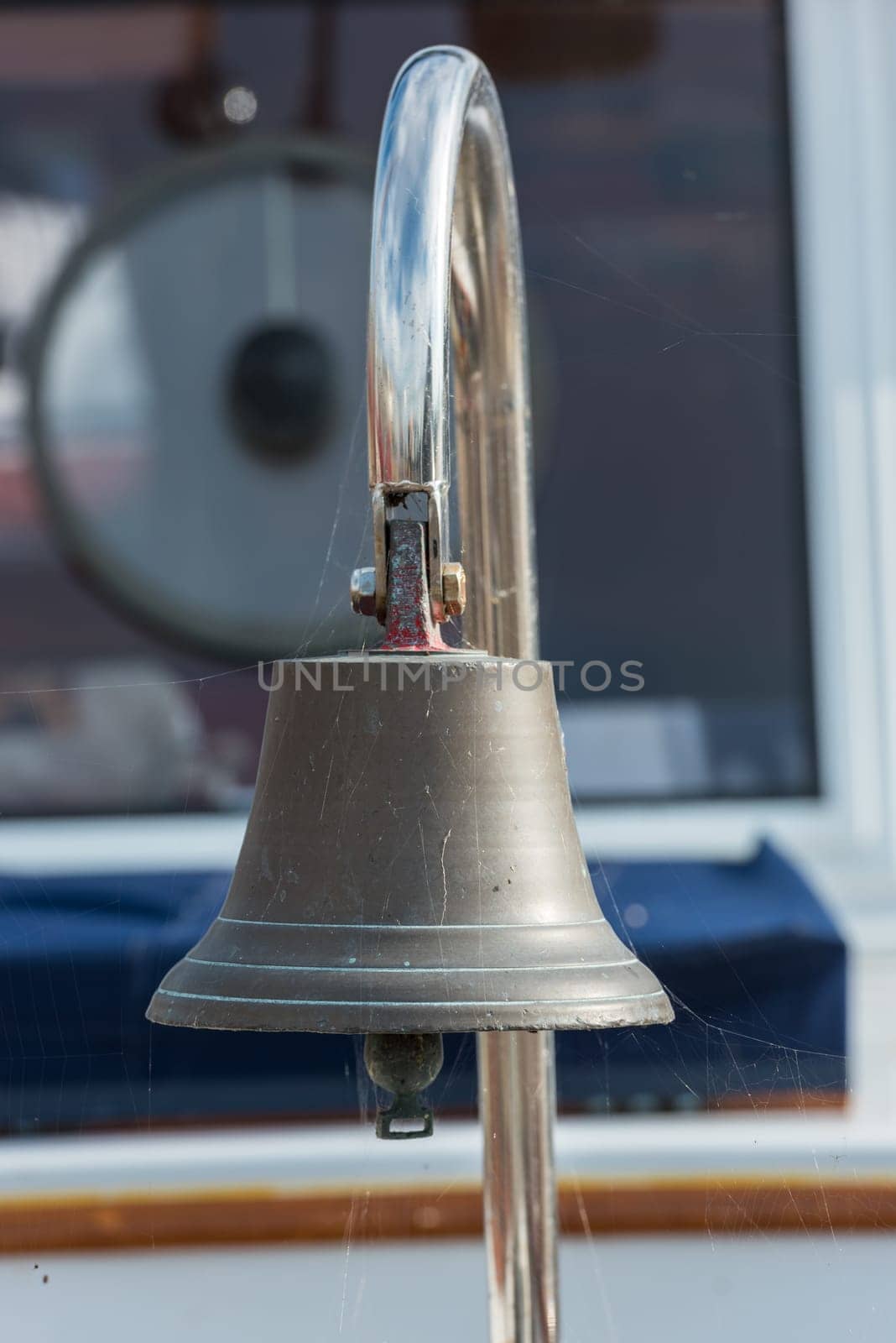 Brass ship bell on a classic sailboat. Close Up