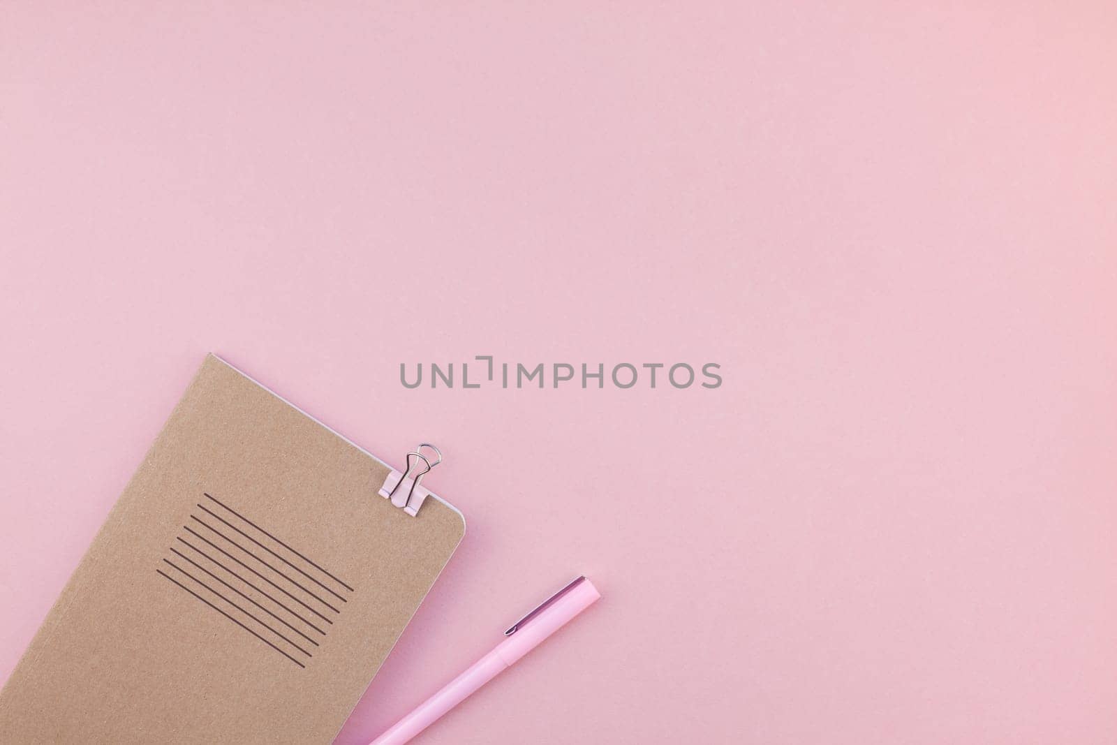 Top view flat lay of woman workspace desk styled design office supplies with copy space on a millennial pink color paper background minimal style. Template for feminine blog social media