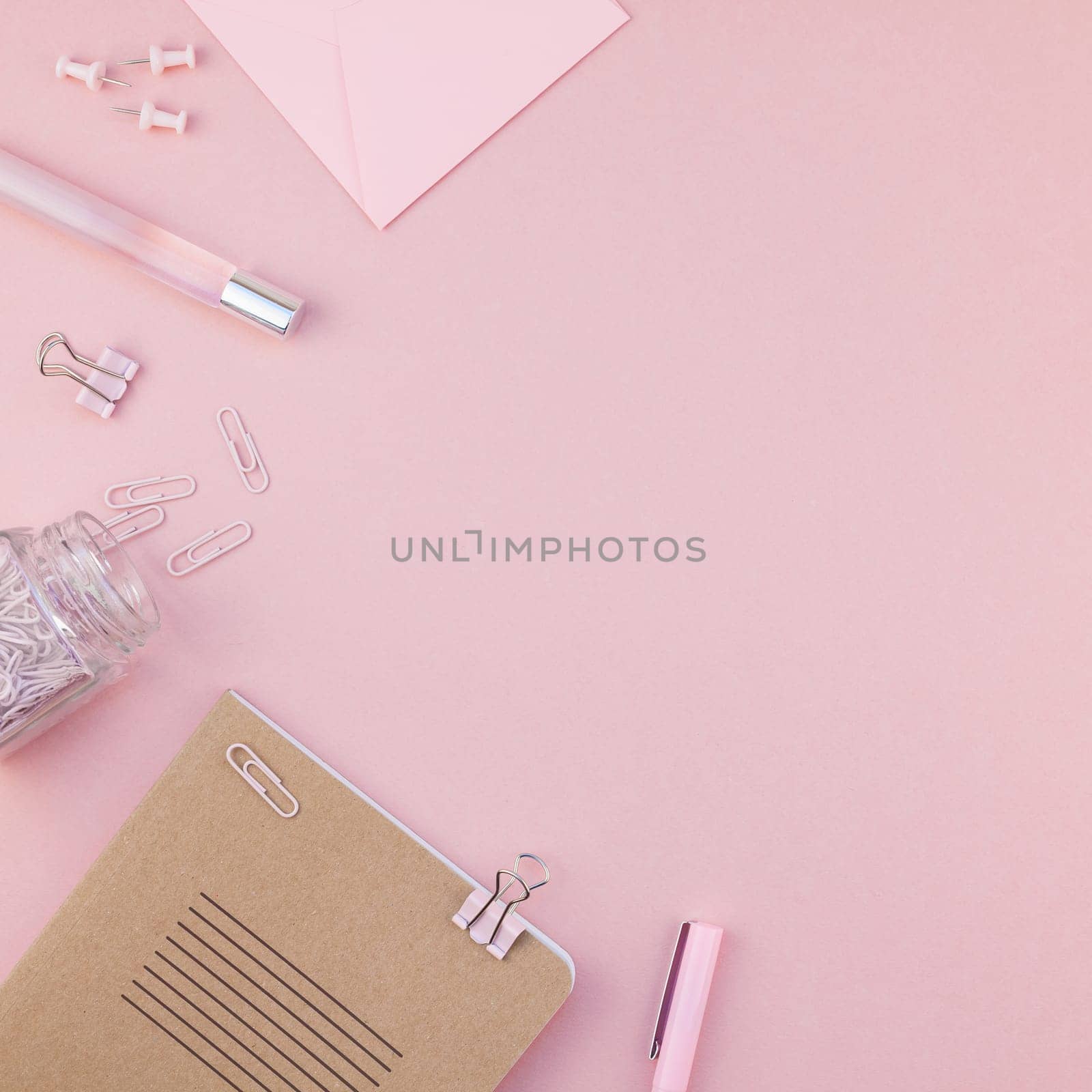 Top view flat lay of woman workspace desk styled design office supplies with copy space on a millennial pink color paper background minimal style. Square Template for feminine blog social media