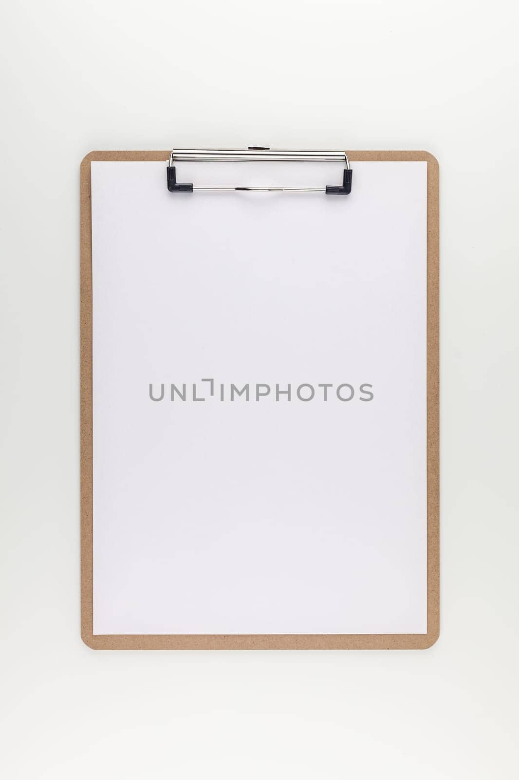 Creative top view mock up of workspace desk styled recycled empty clip board with copy space white table background minimal eco style. Concept start up or new day. Presentation, design, text template