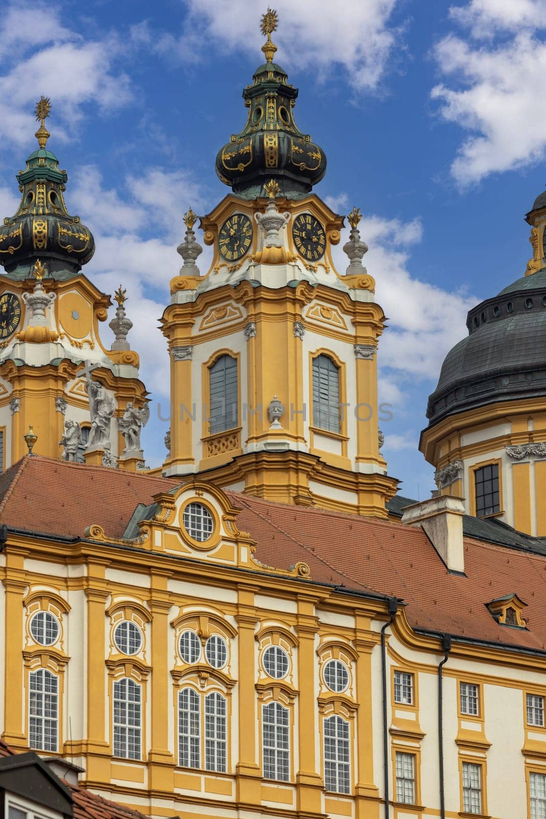Melk, Austria - February 24, 2023: View of Melk Abbey with Collegiate Church towers on background of blue sky. It was was founded in 11th century, today's baroque abbey was built in 18th century