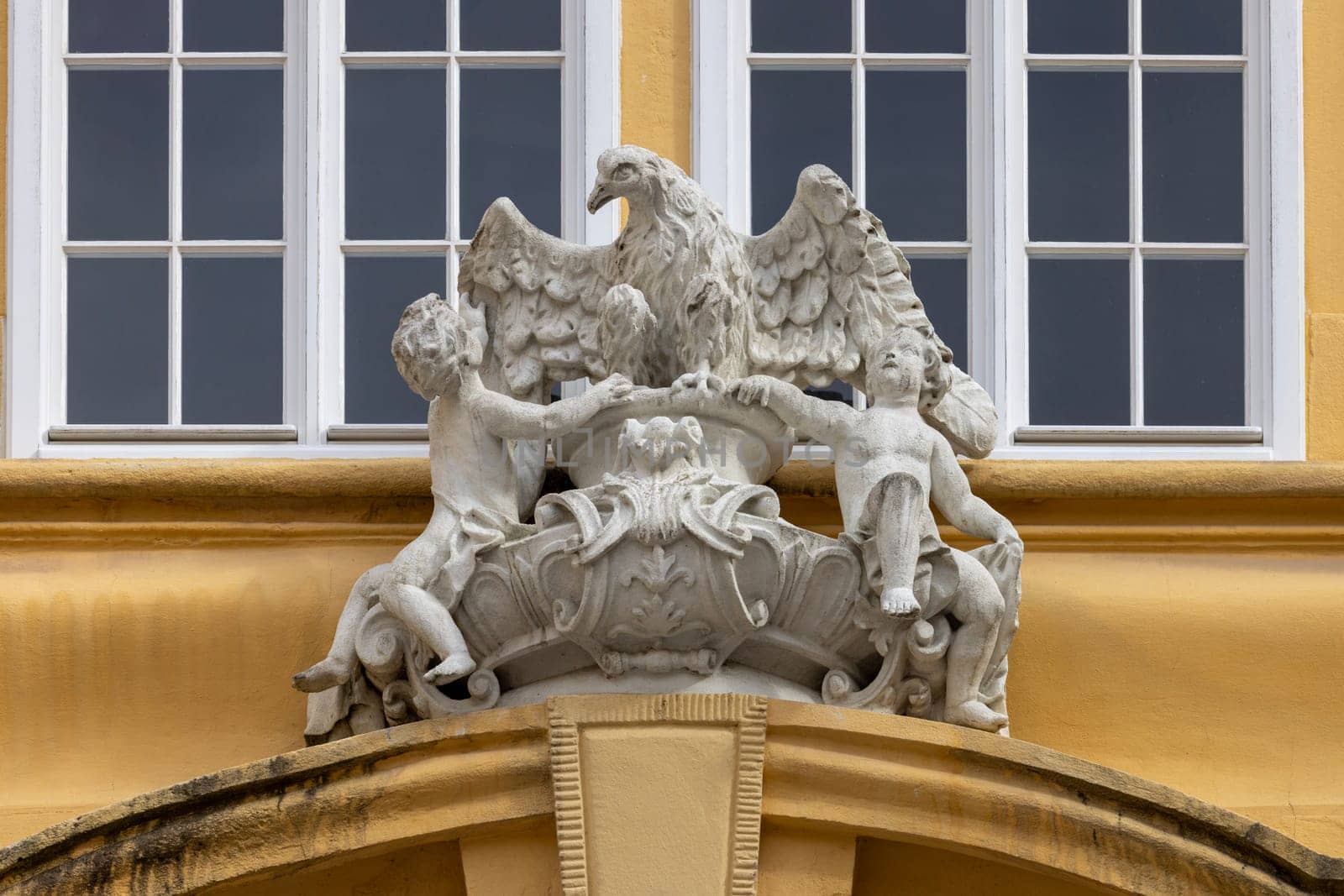 Melk, Austria - February 24, 2023: Melk Abbey on hill above town, decorative relief on facade. Monastery was founded in 11th century, today's baroque abbey was built in 18th century